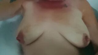 Playing with my tits in a bubble bath